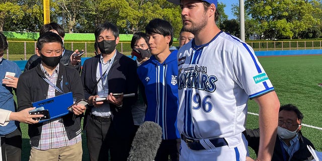 Yokohama BayStars Trevor Bauer is surrounded by the reporters in Yokosuka, Japan, Sunday, April 16, 2023.