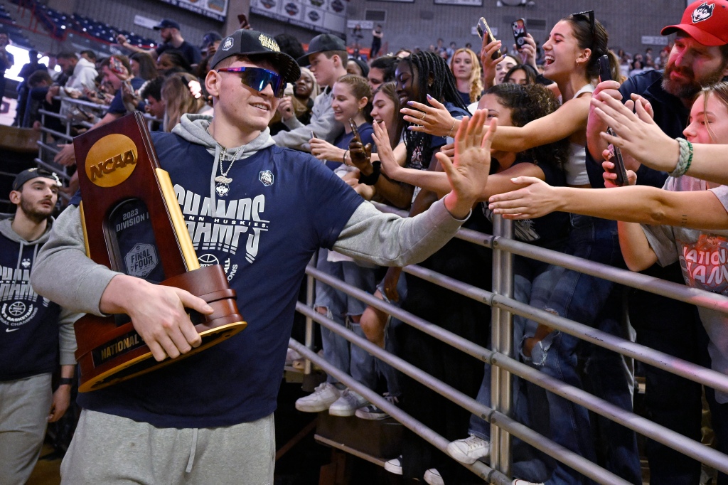 UConn's Donovan Clingan is greeted by fans as the team arrives for a rally at Gampel Pavilion in honor of UConn's NCAA men's Division I basketball championship, Tuesday, April 4, 2023, in Storrs, Conn.
