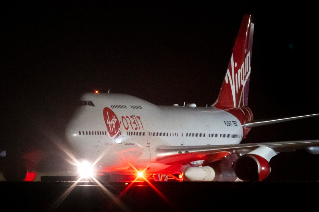 A general view of Cosmic Girl, a repurposed Boeing 747 aircraft carrying the LauncherOne rocket under its left wing, as final preparations are made at Cornwall Airport Newquay on January 9, 2023 in Newquay, United Kingdom.