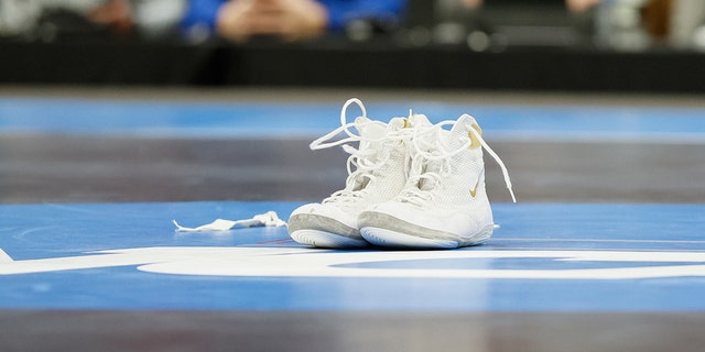 Gable Steveson of the Minnesota Golden Gophers leaves his shoes on the mat following his win over Cohlton Schultz of the Arizona State Sun Devils in the 285-pound final match during the Division I Mens Wrestling Championship held at Little Caesars Arena on March 19, 2022 in Detroit, Michigan.