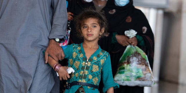 Afghan refugees arrive to Dulles International Airport on Friday, Aug. 27, 2021, after leaving Afghanistan as it fell to the Taliban. Some evacuees are American citizens or reside in the U.S. and were visiting Afghanistan at the time of the take over.