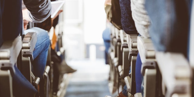 A commercial airliner cabin packed with passengers. Health experts advise that people get up and move around every so often on long flights. Other good advice includes stretching the feet and calves to help blood flow. 