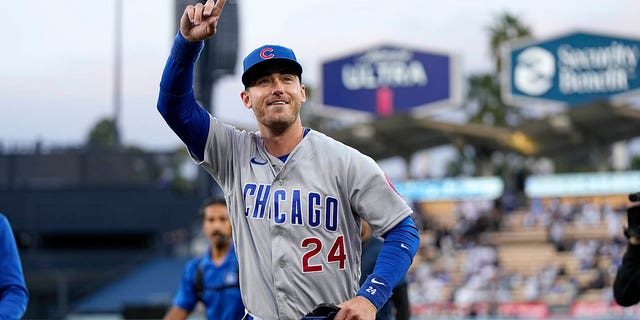 Chicago Cubs center fielder and former Los Angeles Dodger Cody Bellinger gestures to the crowd after being acknowledged by the Dodgers prior to a game Friday, April 14, 2023, in Los Angeles.