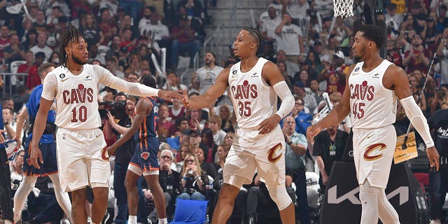 Darius Garland #10 high fives Isaac Okoro #35 of the Cleveland Cavaliers during the 2023 Round 1 Game 1 NBA Playoffs against the New York Knicks on April 15, 2023 at Rocket Mortgage FieldHouse in Cleveland, Ohio. 