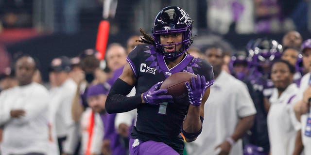 TCU Horned Frogs wide receiver Quentin Johnston catches a pass for a first down during the game against the Kansas State Wildcats at AT&amp;T Stadium in Arlington, Texas, on Dec. 3, 2022.