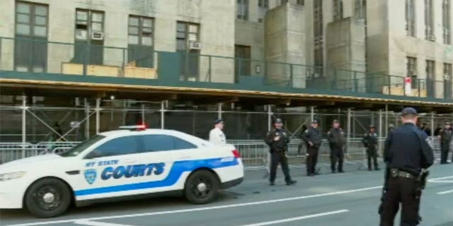 Cops line up outside of Manhattan court ahead of Trump arraignment.