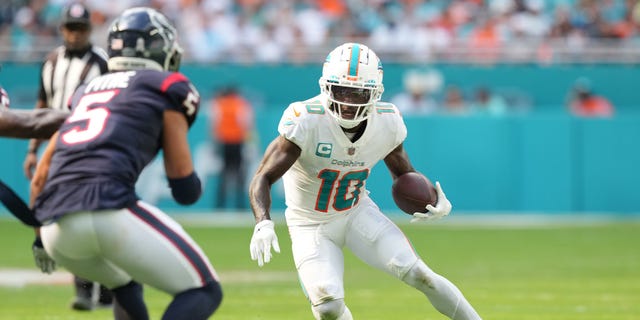 Tyreek Hill (10) of the Miami Dolphins runs the ball during the first quarter in a game against the Houston Texans at Hard Rock Stadium Nov. 27, 2022, in Miami Gardens, Fla.