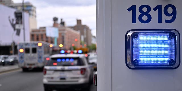 NYPD vehicles wait on the street