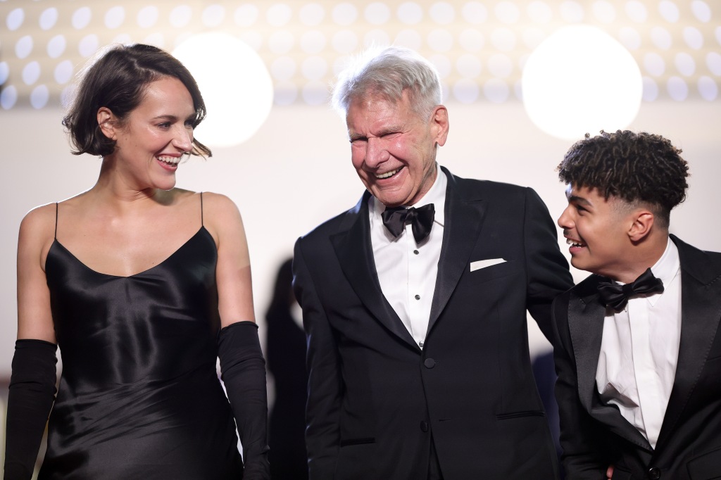Harrison Ford (center) was beaming with co-stars Phoebe Waller-Bridge and Ethann Isidore, despite their mere six-minute standing ovation at Cannes.