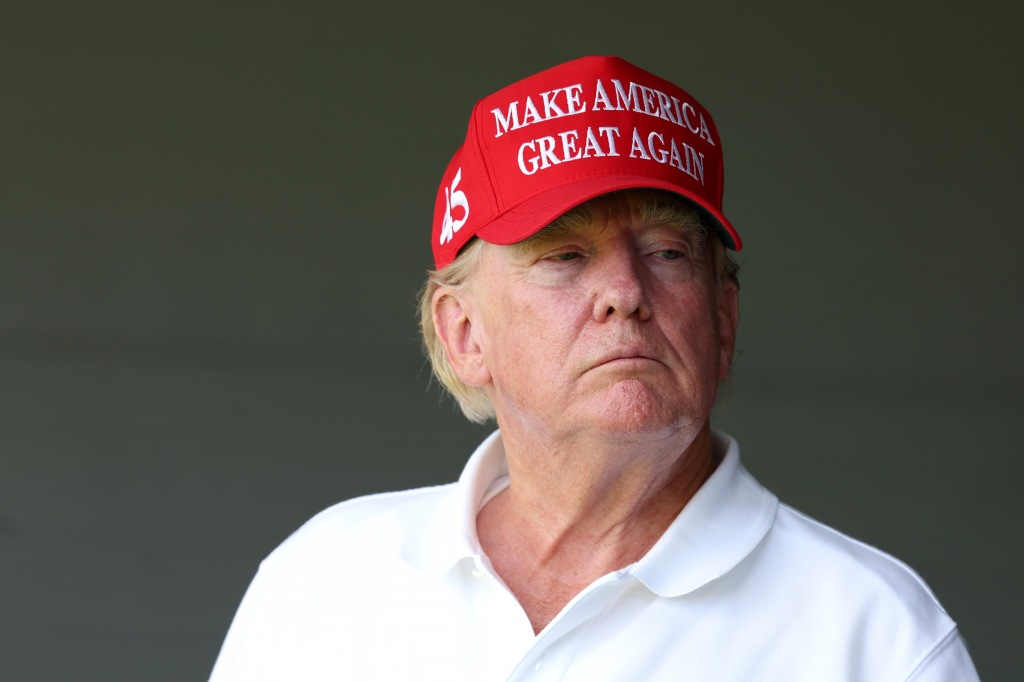 Former US President Donald Trump watches from a box on the 18th green during day one of the LIV Golf Invitational on May 26, 2023 in Sterling, Virginia.