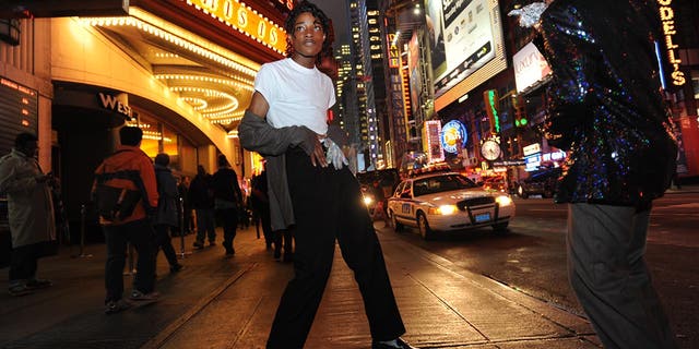 Two Michael Jackson impersonators on the street in at night