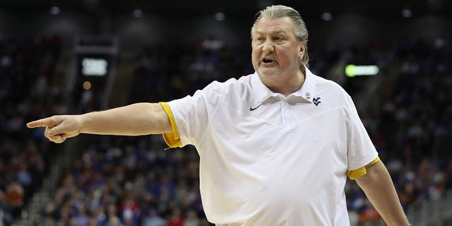 Bon Huggins of West Virginia coaches against Kansas