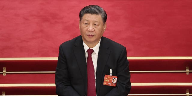 Chinese President Xi Jinping sitting at a session