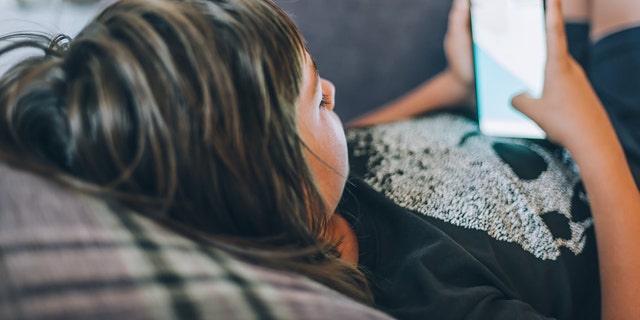 Teen scrolling on phone