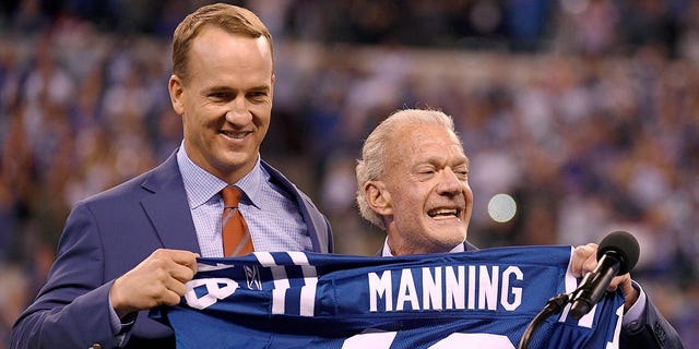 Peyton Manning stands with Colts owner Jim Irsay at his jersey retirement ceremony