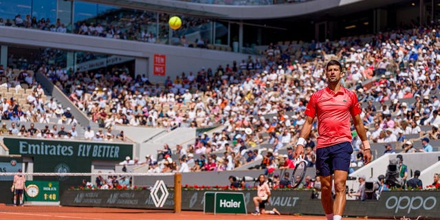 Novak Djokovic plays during the first round of the French Open