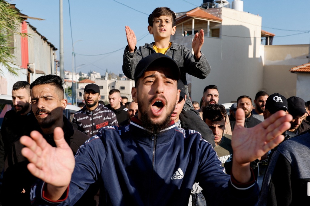 People react as Palestinians rally near Jenin in the Israeli-occupied West Bank on May 2, 2023. 