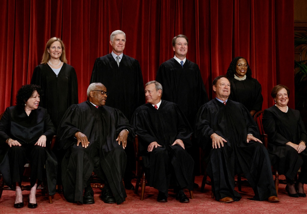 U.S. Supreme Court justices pose for their group portrait at the Supreme Court.
