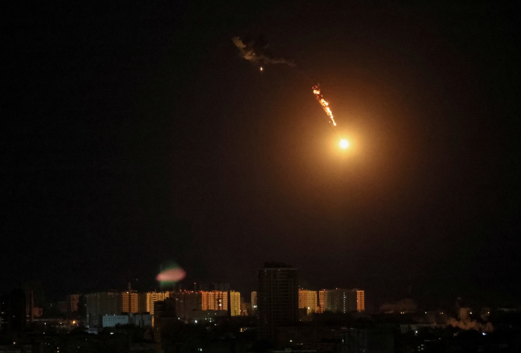 A drone explosion is seen in the sky over the city during a Russian attack on Ukraine, in Kyiv, on May 8, 2023. 