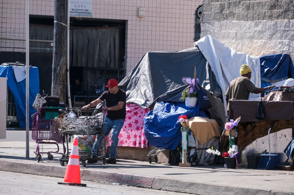 Homeless people are seen in the Skid Row district of Los Angeles.