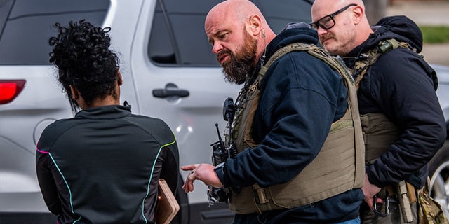 U.S. Marshal speaks with woman