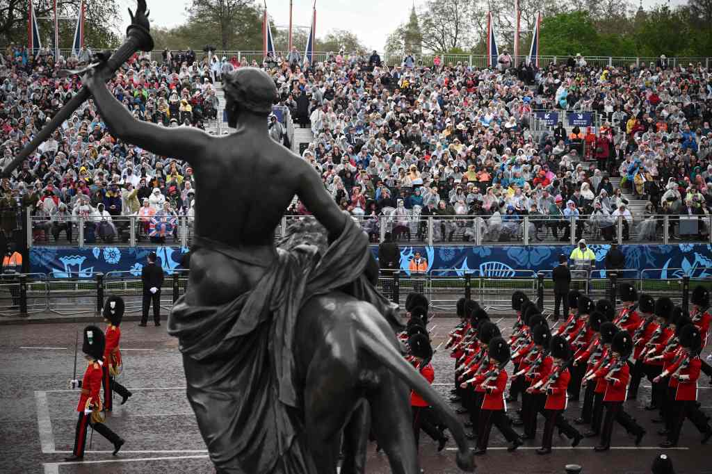 Thousands of spectators lined the streets of London under gray, misty skies and cheered for their new king.