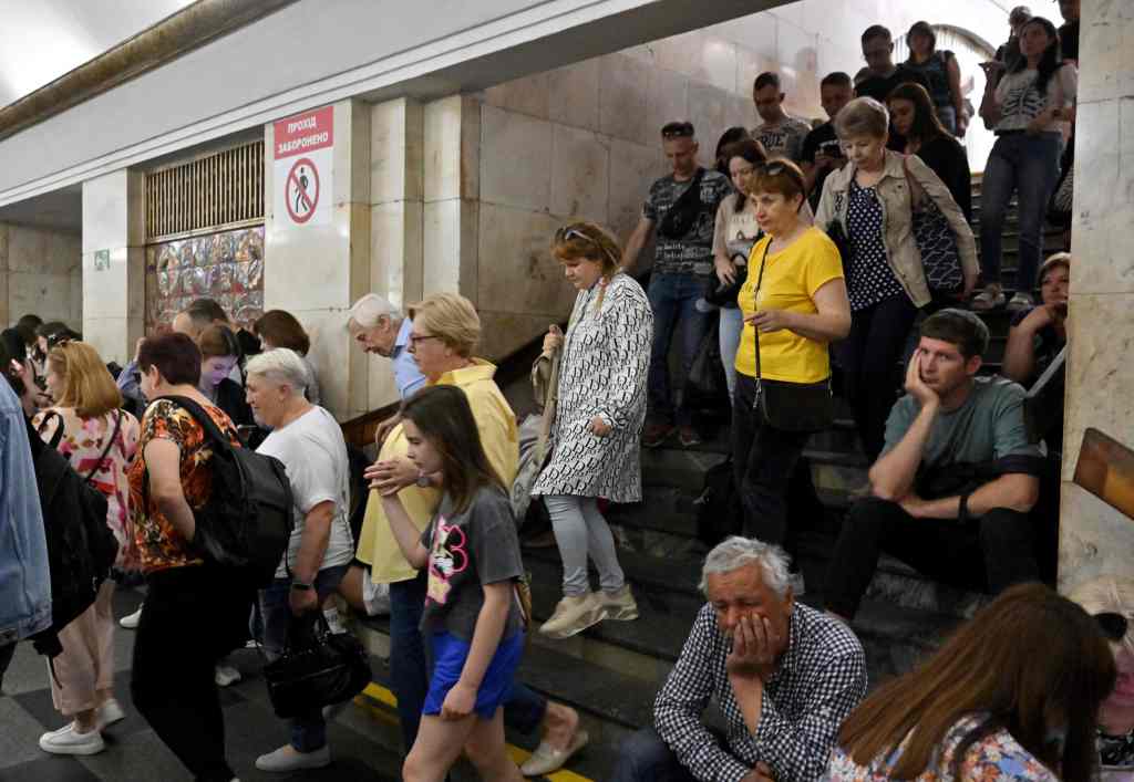 Local residents take shelter in a metro station in the center of Kyiv during a Russian missile strike on May 29, 2023. 