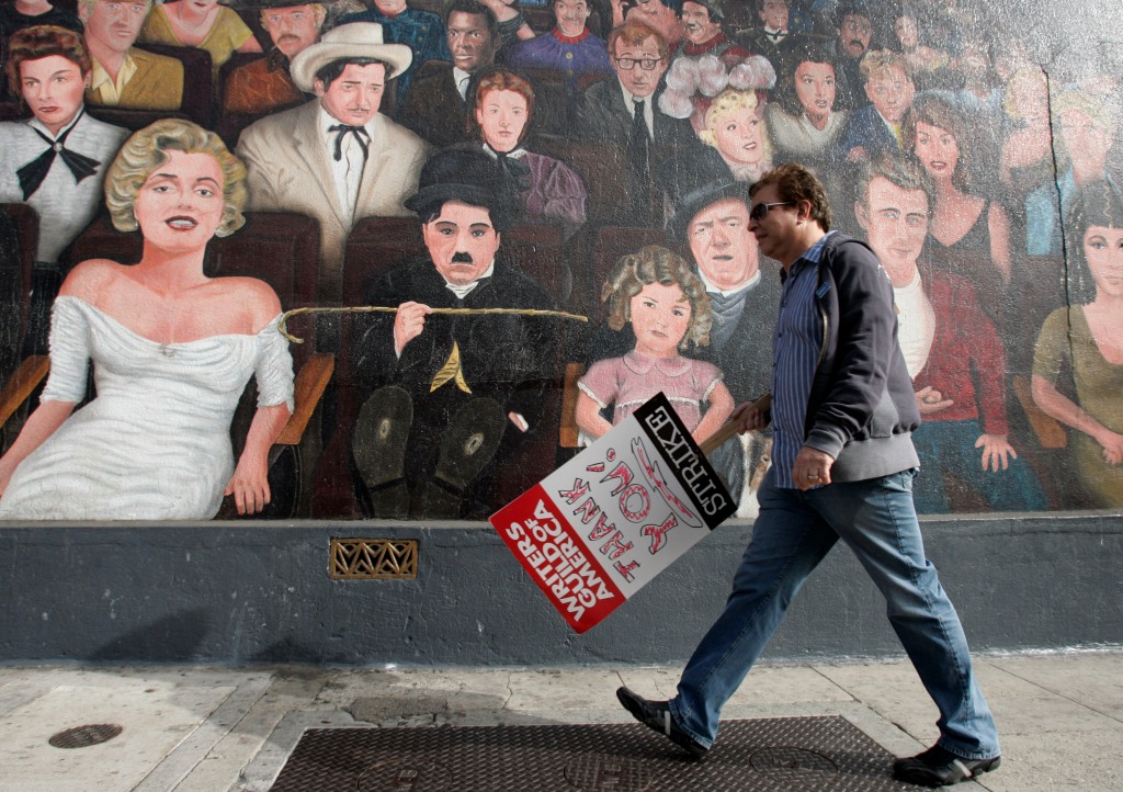 Writer Steve Byrnes walks past a mural depicting Hollywood actors as he joins thousands of people from unions joining Writers Guild of America on a march down Hollywood Boulevard in the third week of the WGA strike on Nov. 20, 2007.