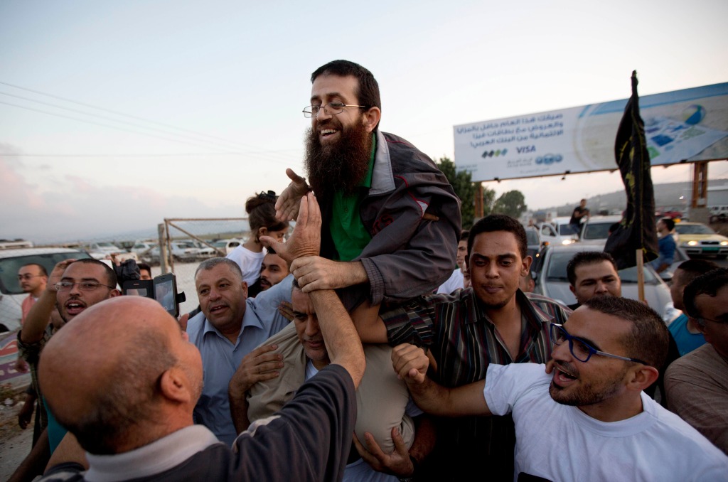 Palestinian Khader Adnan, center, is greeted by Palestinians after his release from an Israeli prison in the West Bank village of Arrabeh near Jenin, on July 12, 2015. 