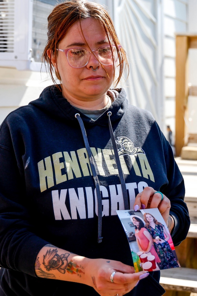 Ashleigh Webster shows a photo of Ivy Webster and Tiffany Guess at her home in Henryetta, Okla., on May 2, 2023.