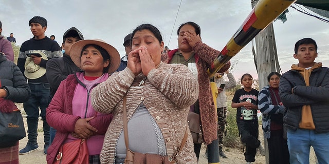 A photo of victims' relatives outside the mine