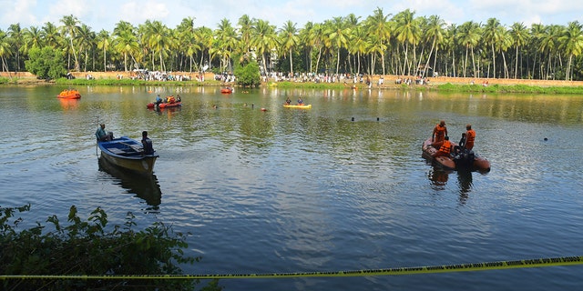 People in small boats searching for victims in water