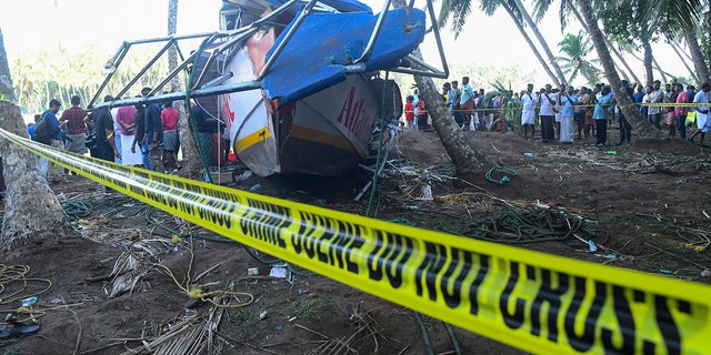 Caution tape in front of a capsized boat