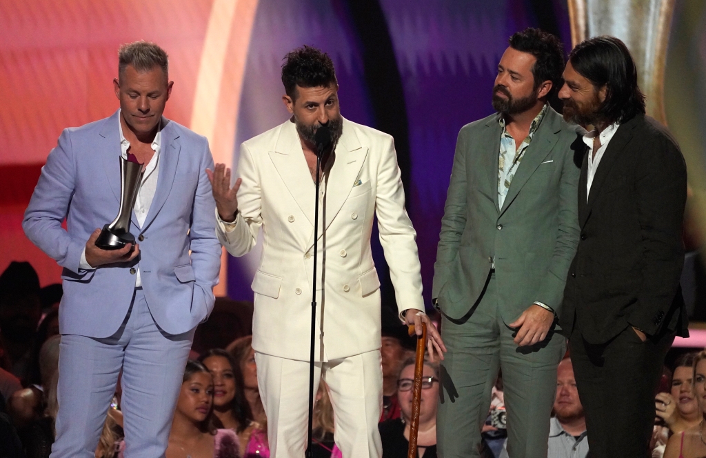 Trevor Rosen, from left, Matthew Ramsey, Brad Tursi, and Geoff Sprung of Old Dominion accept the award for group of the year at the annual Academy of Country Music Awards on May 11, 2023, at the Ford Center in Frisco, Texas. 