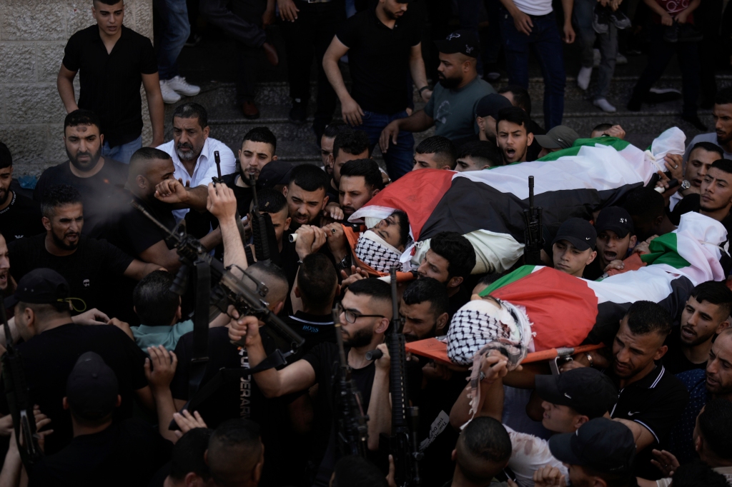 Palestinian mourners carry the bodies of Said Mesha and Adnan Araj during their funeral in the Balata refugee camp near the West Bank town of Nablus.