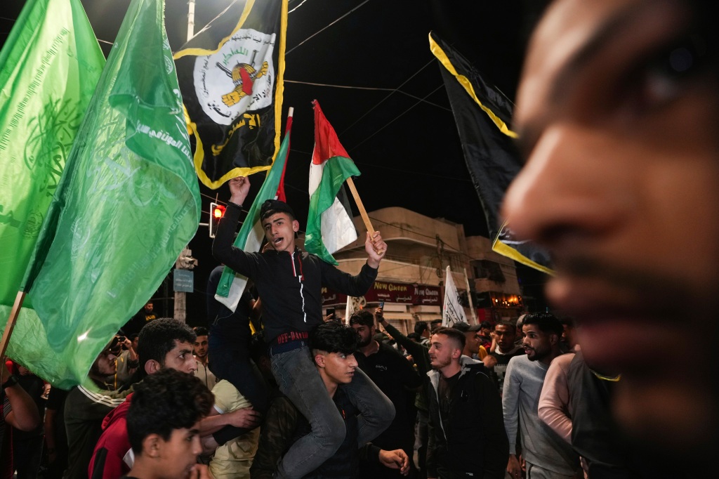 Palestinians celebrate the announcement of a cease-fire after five days of fighting between Israel and the Islamic Jihad militant group in Gaza City.