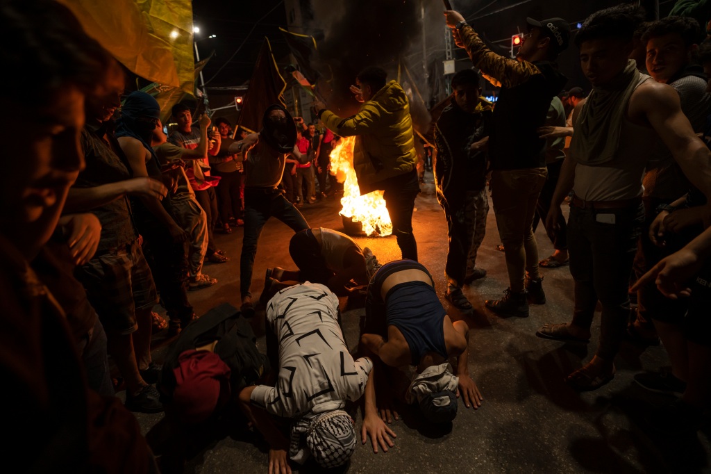 Palestinians celebrate the announcement of a cease-fire after five days of fighting between Israel and the Islamic Jihad militant group in Gaza City, Saturday, May 13, 2023.