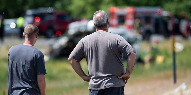 A bystander looks on