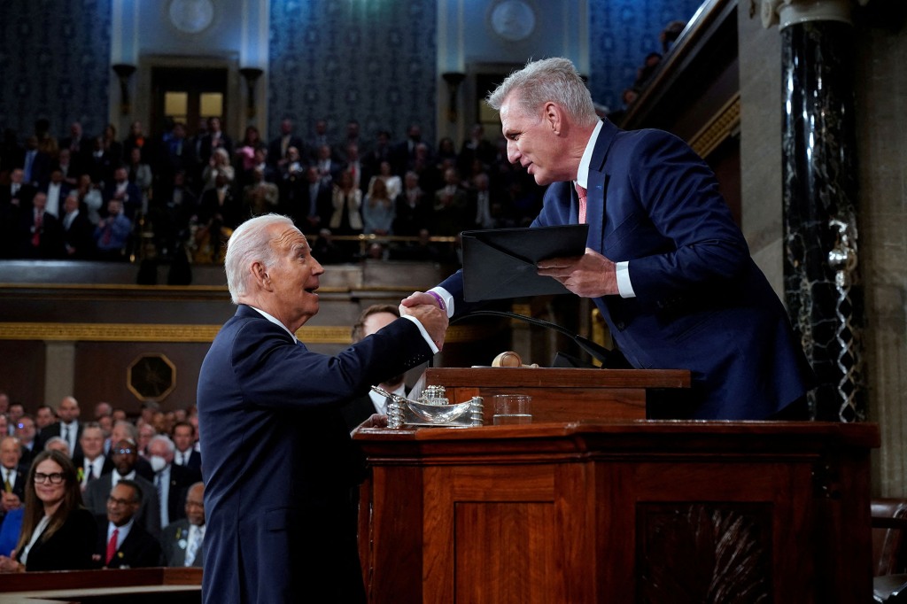  Biden shakes hands as he presents a copy of his speech to House Speaker Kevin McCarthy of California, before he delivers his State of the Union address to a joint session of Congress, at the Capitol in Washington, U.S., February 7, 2023. 