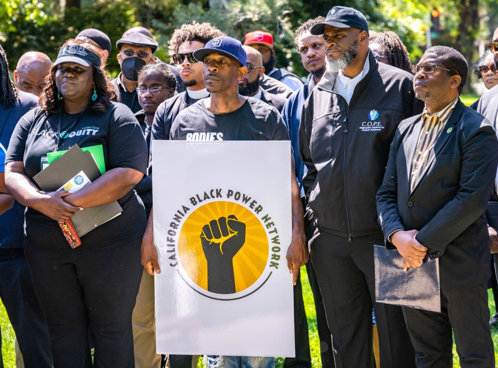 Supporters listen as speakers share their views on reparations and other issues during the Black Power Network news conference at the state Capitol in Sacramento, Calif., on May 10, 2023.