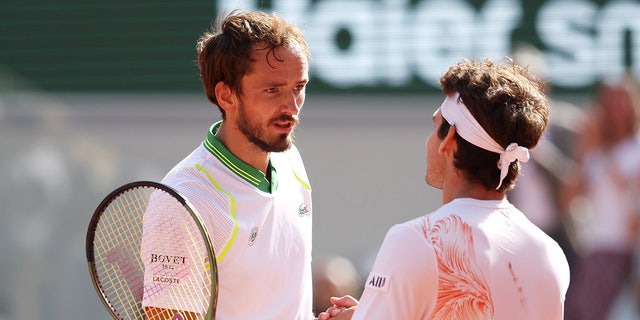 Daniil Medvedev shakes hands with Thiago Seyboth