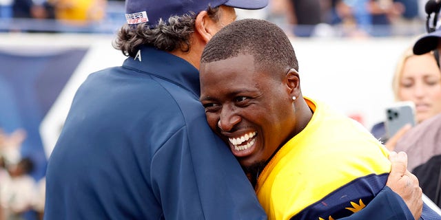 Derrick Dillon hugs Todd Haley