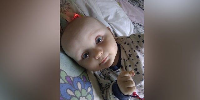 Toddler Finley Boden is pictured lying in his crib