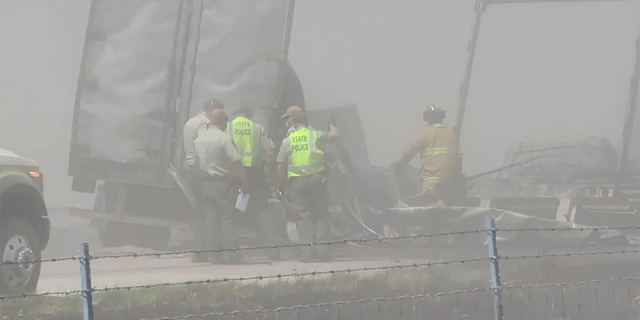 Several emergency workers by a truck