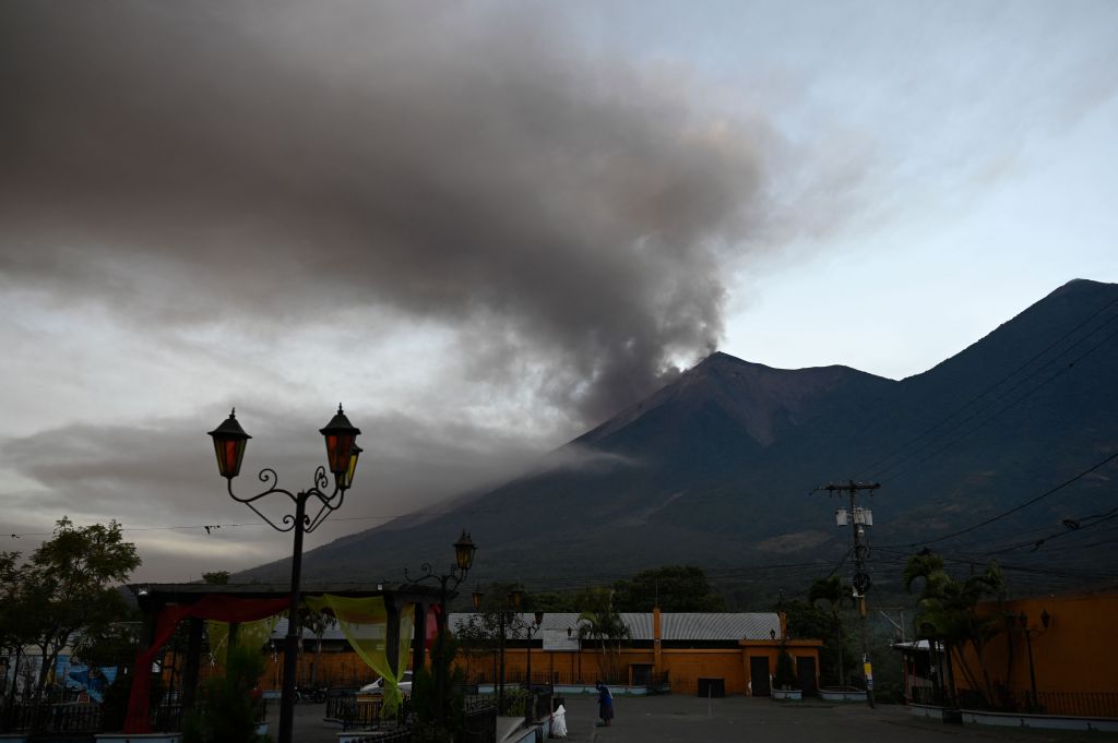 A plume of ash and smoke rises from the Fuego volcano after its eruption, as seen from Alotenango near Guatemala City on Dec. 11, 2022. 