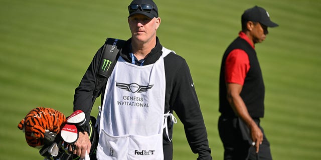 Tiger Woods walks with caddie Joe LaCava a the The Genesis Invitational