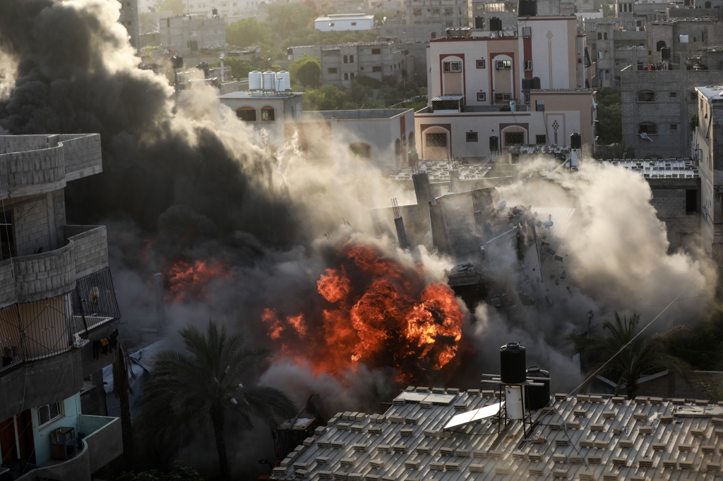 A picture shows a house being hit by an Israeli air strike in Gaza city on May 13, 2023.