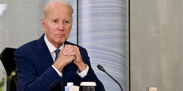 Biden folding hands at G-7