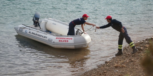 Investigators on a boat in the Arade dam