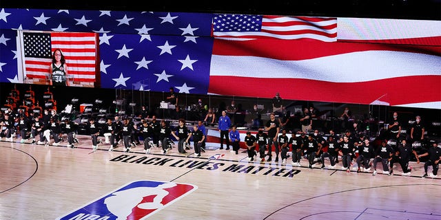 Players take a knee during the NBA Bubble